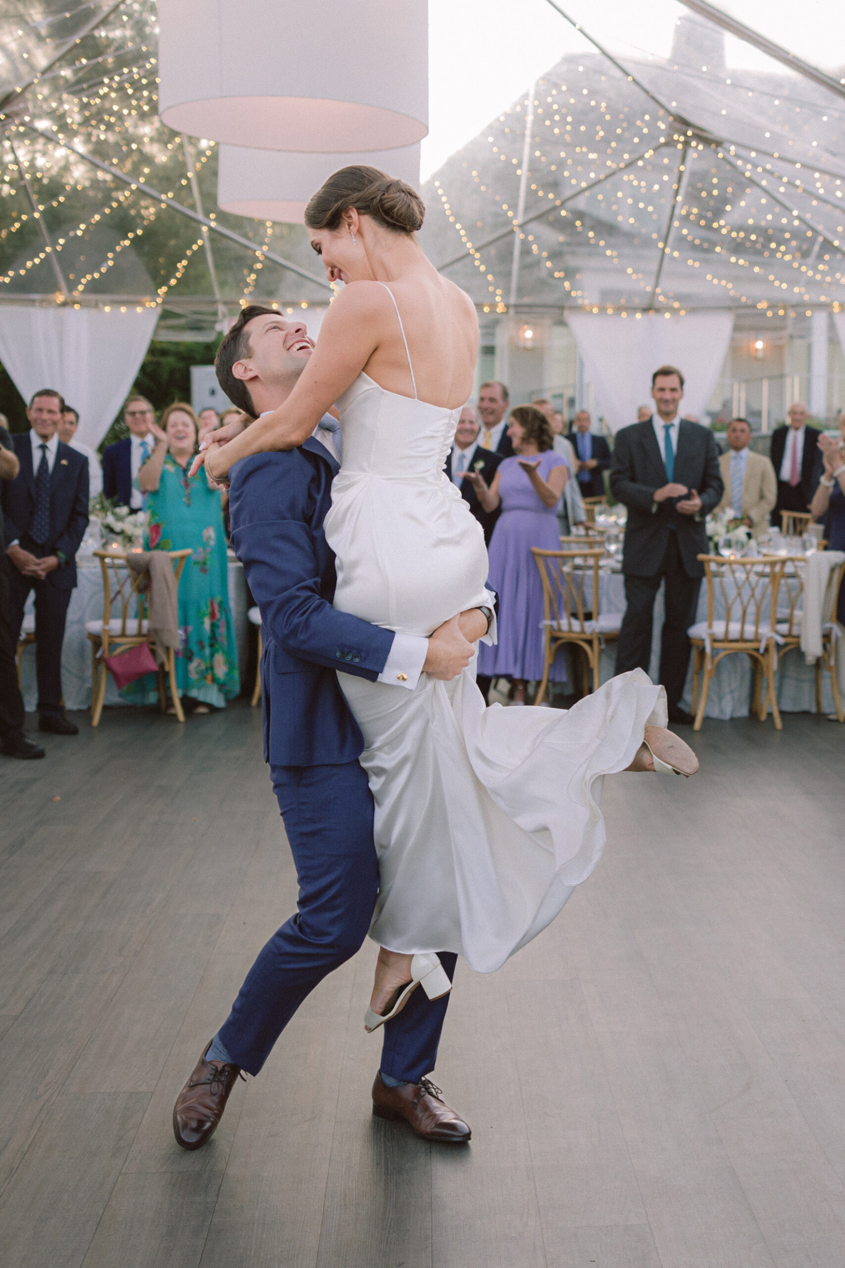 A groom lifts his bride in the air beneath a clear tent strung with lights as guests smile and applaud. best wedding photographers in Connecticut
best wedding photographers in New York city
best wedding photographers in tri-state area
Connecticut wedding photographer
Connecticut wedding planning
getaway wedding photographer
Litchfield county wedding photographer
Manhattan wedding planning
New York wedding photographer
travel wedding photographer
wedding day schedule
wedding day schedule template
wedding day timeline
wedding planning tips
wedding schedule template
when to start getting ready on my wedding day