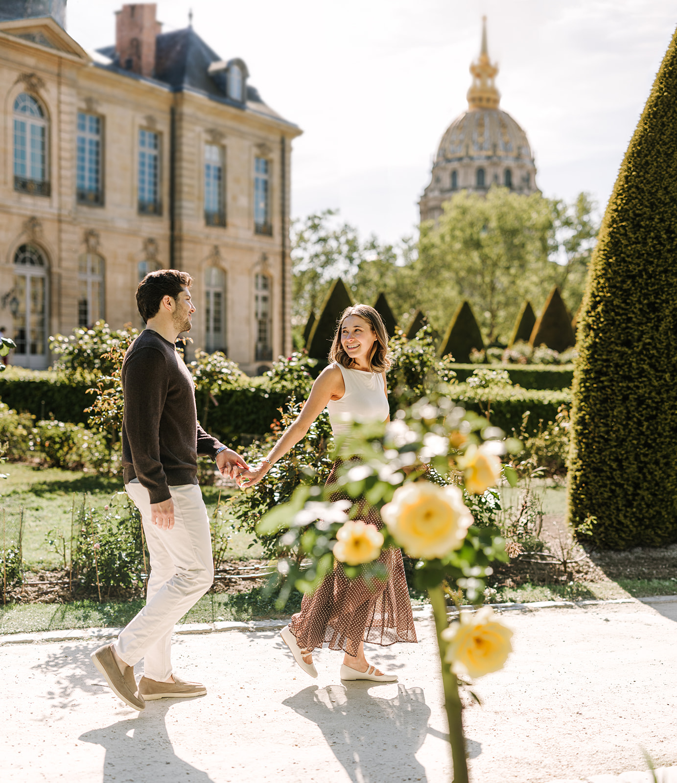 Couple Holding Hands Walking Through Gardens at Musée Rodin in Paris