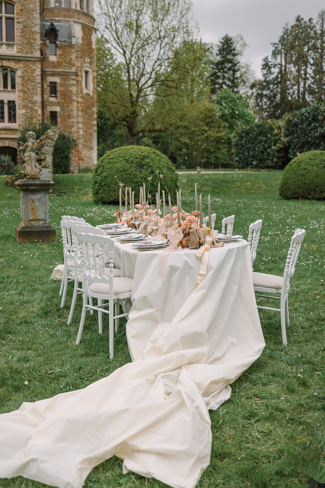 outdoor wedding reception on lawn of chateau in French countryside