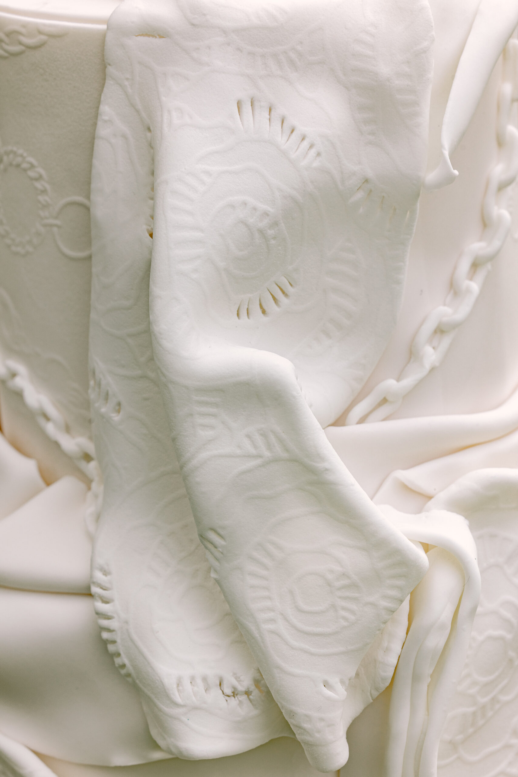 wedding cake with draped, lace like details