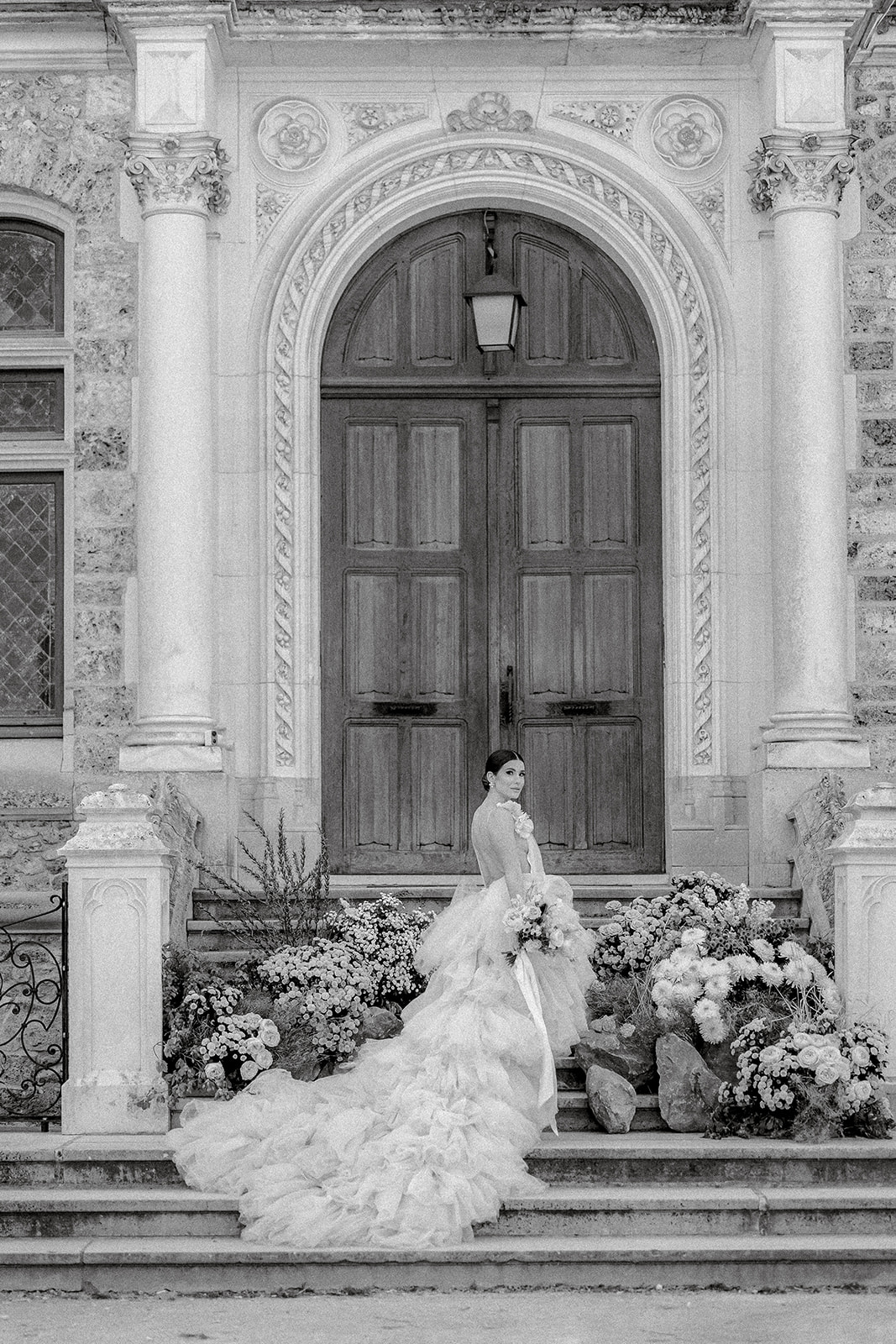 bride posting for portraits on stairway of Château de Méridon, Chevreuse, France