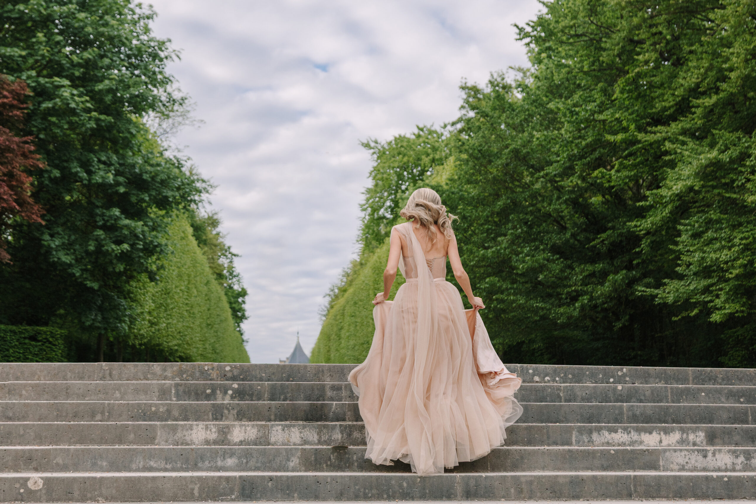 Bride to be Ascending Stone Stairway in Gardens at Château de Sceaux