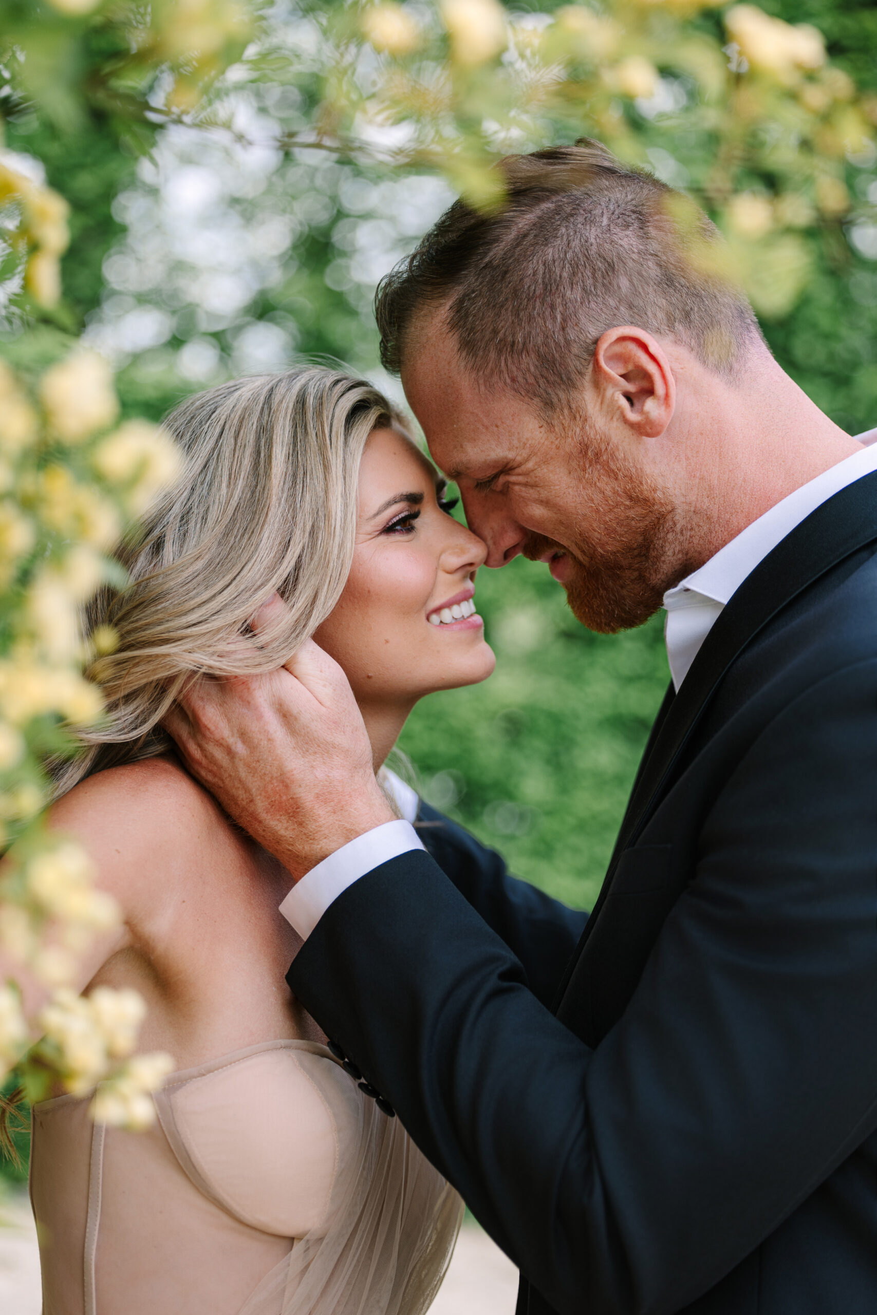 Engaged Couple Embrace in Gardens of Château de Sceaux, Paris, During Spring, yellow spring flowers in paris